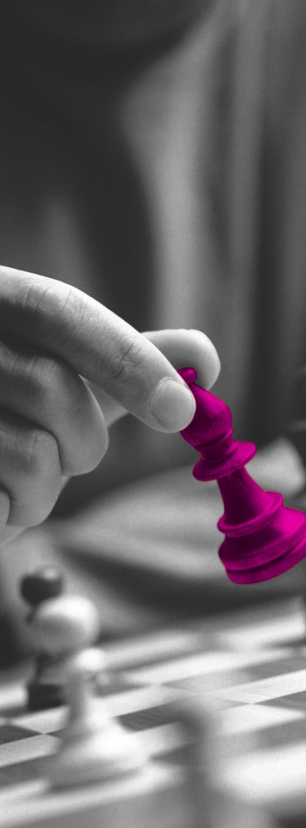Hand moving a magenta chess piece