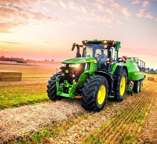 Tractor working a field at sunset